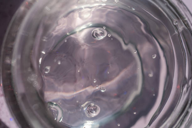 istock Transparent gel in a jar on a lilac background. 1341588993