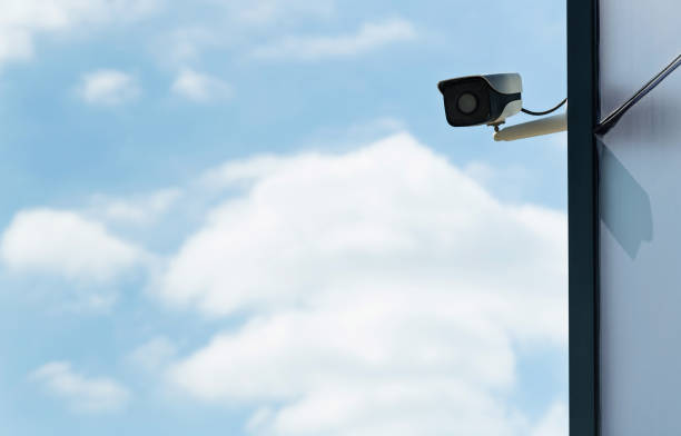 Security camera on the wall of modern office building.
