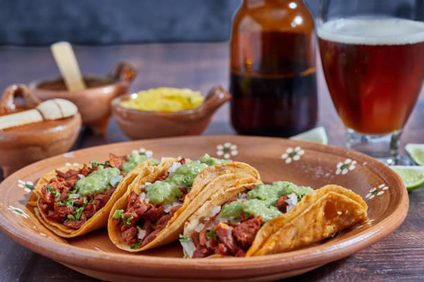 Tacos al pastor, traditional Mexican food, with onion, cilantro, pineapple, red sauce or guacamole.