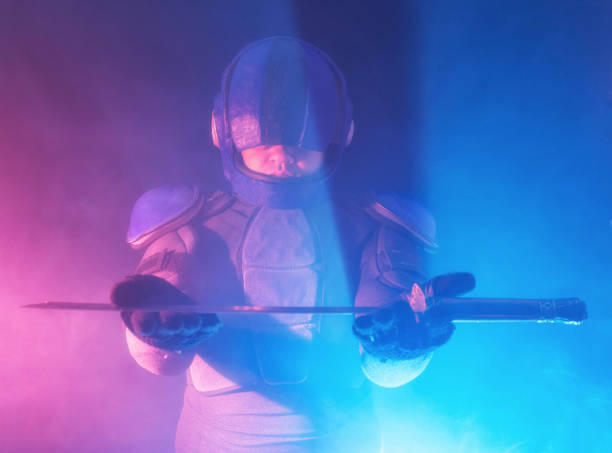 istock Cyberpunk future concept. Bionic cyborg police officer with short samurai sword stands in dark with smoke, fume. Halfman robot looks at camera. Futuristic science fiction scene. 1341594130