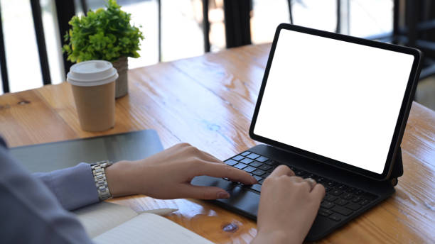 istock Businesswoman working online with computer tablet on wooden table. 1341594351