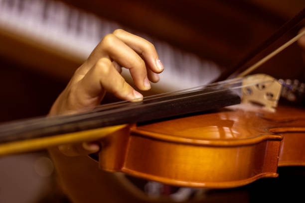 istock left hand of a young violinist presses the strings on the violin neck, horizontal 1341599021