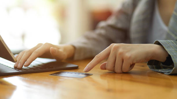 istock Closeup female entering credit card number by using on digital tablet 1341599023