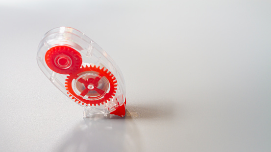 Correction tape for correcting text in the form of a convenient red pencil on a gray background.