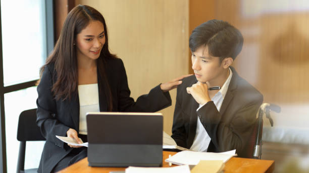 istock Female manager encourage her disabled employee 1341599757