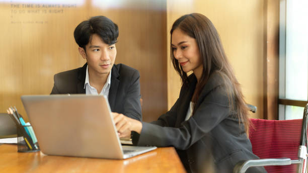 istock Young business couple working together 1341599776