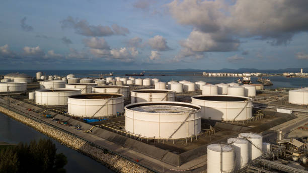 aerial view storage tank farm at night, tank farm storage chemical petroleum petrochemical refinery product at oil terminal, business commercial trade fuel and energy transport by tanker vessel. - oil storage tank storage compartment fuel and power generation imagens e fotografias de stock