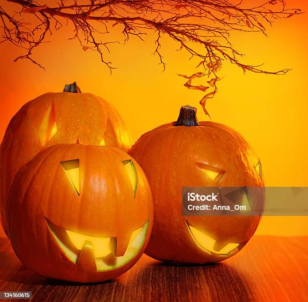 Glowing Halloween Pumpkin Stock Photo - Download Image Now - Autumn, Branch - Plant Part, Candlelight