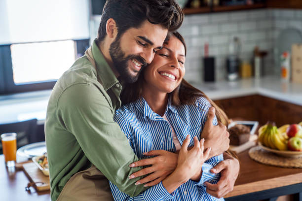 istock Happy couple in love having fun in kitchen at home 1341609459