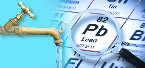 Presence of lead in drinking water - concept with the Mendeleev periodic table and old water brass faucet stock photo