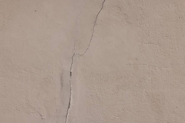 istock Part of an old, cracked painted concrete wall 1341613167