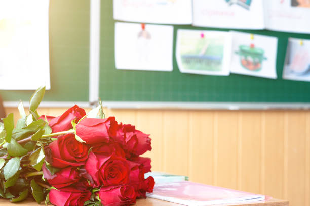 Red roses on teacher's desk in class.