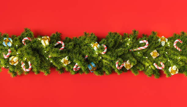 istock Christmas tree garland with gifts and candy ornaments 1341616385