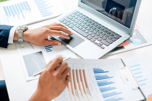 istock Business man is checking and auditing the business performance with a help from his college. Analyzing the revenue and auditing the budget concept. 1341619224
