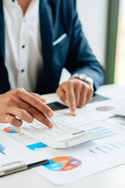 Photo of businessman checking financial report in his office