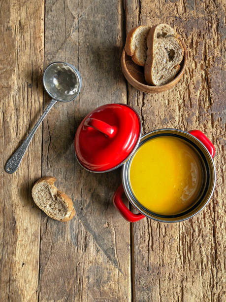 istock pumpkin soup in a small red pot on the wooden table 1341621384