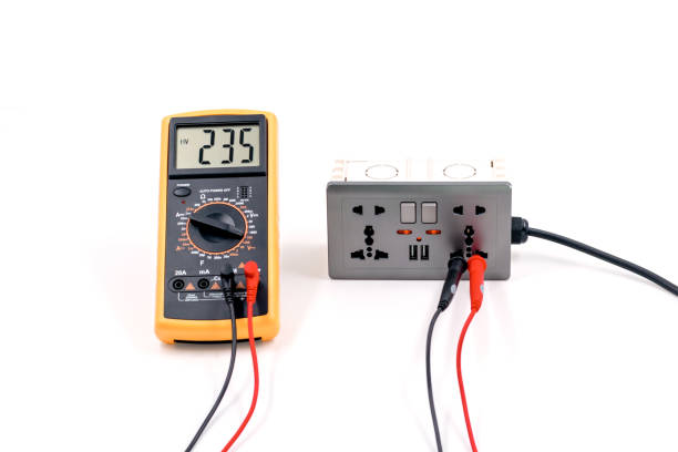istock Using a digital meter to measure the voltage at a electric socket box . 1341621707