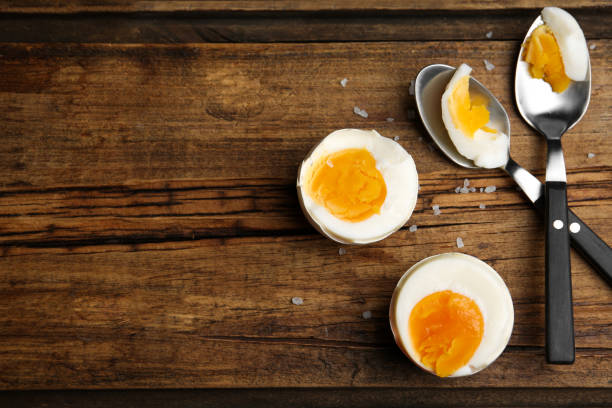 istock Tasty boiled chicken eggs on wooden table, flat lay. Space for text 1341621763