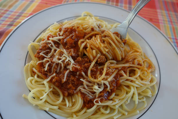 istock Cooked spaghetti served with Bolognese sauce and grated cheese 1341625687