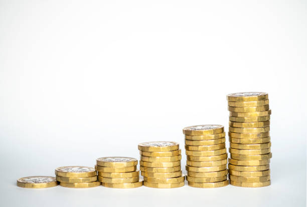 Stacks of one pound coins Stacks of one pound coins against a white background. one pound coin stock pictures, royalty-free photos & images