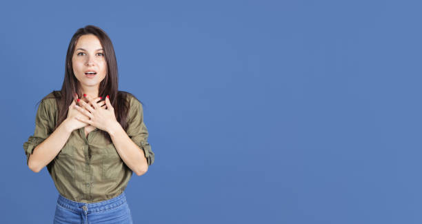 istock One beautiful impressed girl posing isolated over blue background. Flyer 1341627244