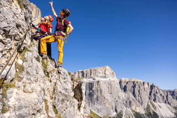 istock Alpine mountain guide climbing with family hiking group 1341627454