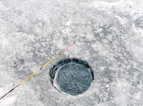 Fishing line in a hole drilled in the ice.