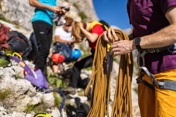 Storytelling of a day of hiking and climbing on the Dolomites: Alpine mountain guide climbing on via ferrata with hiking group