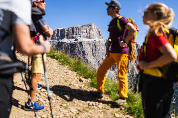 istock Alpine mountain guide climbing with family hiking group 1341628983