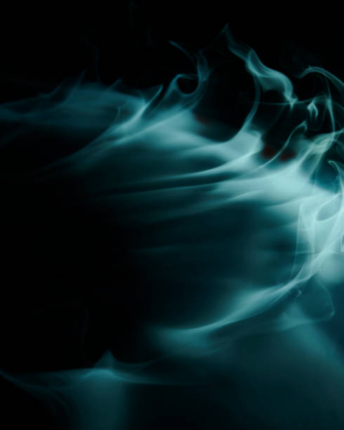 Close up of a smoke cloud. Close up picture of a smoke cloud, shot in studio with colorful lighting. lurie stock pictures, royalty-free photos & images