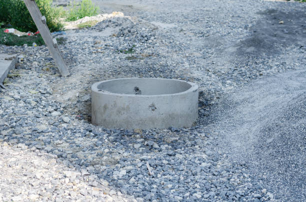 istock Construction site. Open concrete sewage well among the gravel. I 1341631492