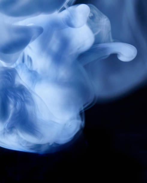 Close up of a smoke cloud. Close up picture of a smoke cloud, shot in studio with colorful lighting. lurie stock pictures, royalty-free photos & images