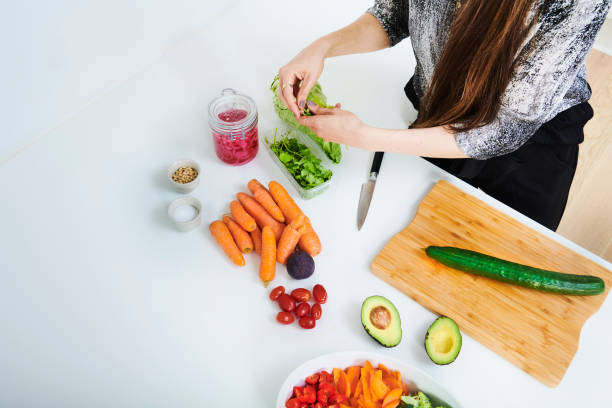 istock Woman cutting cucumber 1341632884