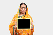 Portrait of Indian woman in saree and showing slate stock photo