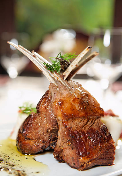 Raw rack of lamb fried with herbs and spices Raw rack of lamb fried with aromatic olive oil, herbs and spices rack of lamb stock pictures, royalty-free photos & images