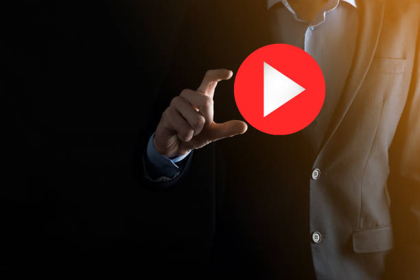 istock Businessman pressing, hold play button sign to start or initiate projects.Video Play Presentation. Idea for business, technology.media player button. Play icon.Go. 1341633266