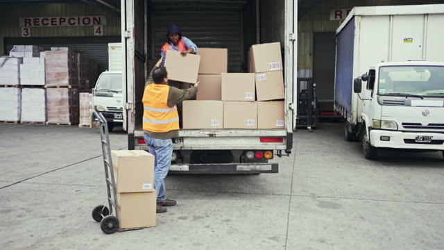 Truck Driver and Warehouseman Unloading Vehicle