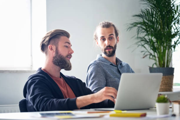 istock Male business executives working in new office 1341633646