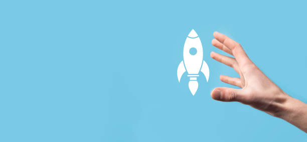 istock Male hand holding rocket icon that takes off, launch on blue background. rocket is launching and flying out, Business start up, Icon marketing on modern virtual interface.Start up concept. 1341633765