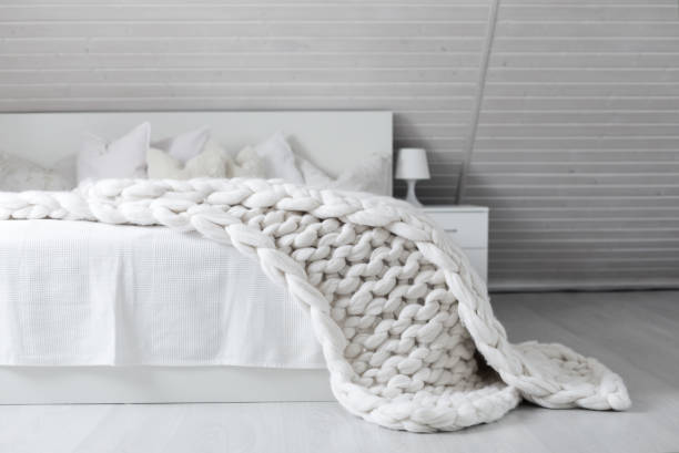 istock White nordic bedroom interior with knit plaid 1341634568