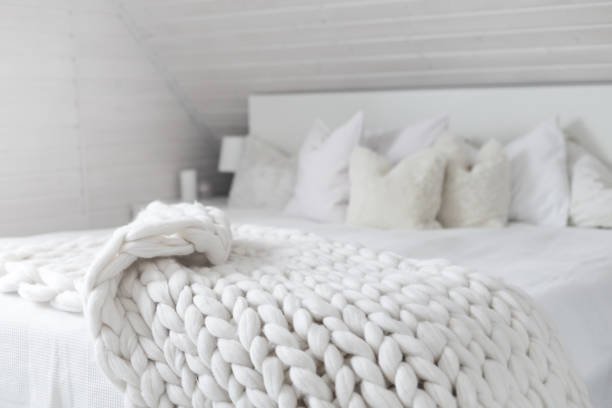 istock White nordic bedroom interior with knit plaid 1341634589