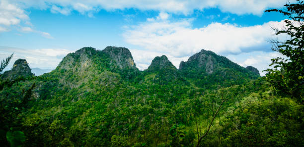 istock Panoramic beautiful green rock mountain with clear blue sky and cloud. 1341637563