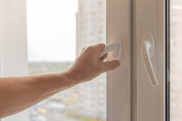 istock man's hand checks quality of plastic windows. 1341637952