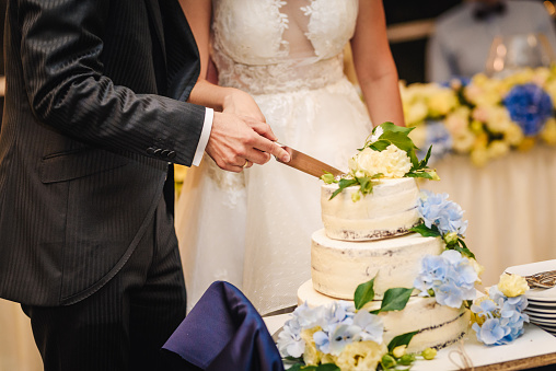 a wedding cake is cut