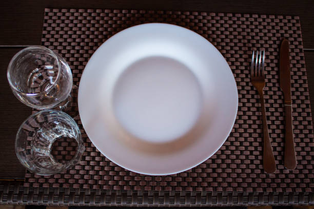 istock table setting white plate fork, knife, glass and glass 1341641787
