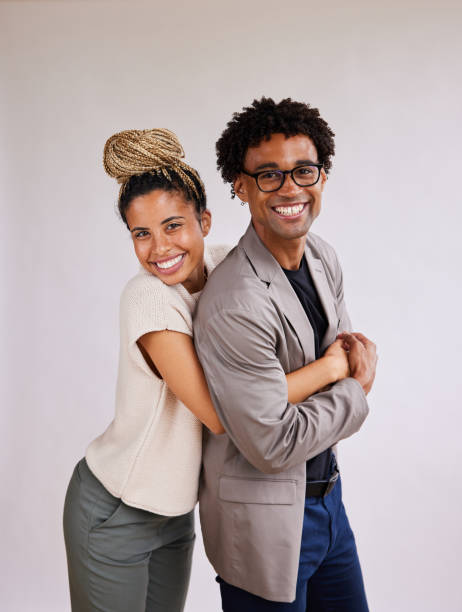 istock Young woman hugging her boyfriend from behind on a white background 1341642821