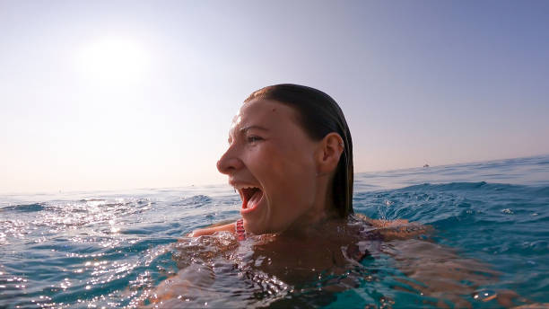 istock Young woman swims through Mediterranean Sea 1341642859