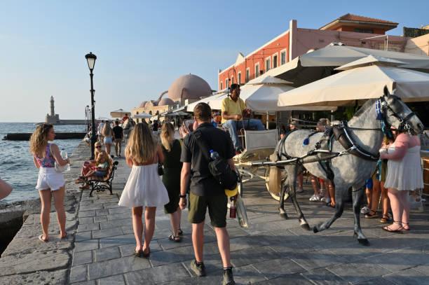 Horse carriage in the center of the city of Chania Chania, July 22: Horse carriage in the center of the city of Chania. Lots of tourists in the summer season on July 22, 2021 at Chania, Crete Island, Greece. crete photos stock pictures, royalty-free photos & images