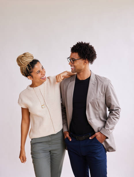istock Smiling young businesspeople looking at each other against a white background 1341643688