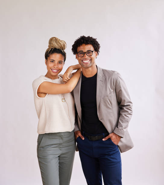 istock Smiling young business colleagues standing against a white background 1341643772